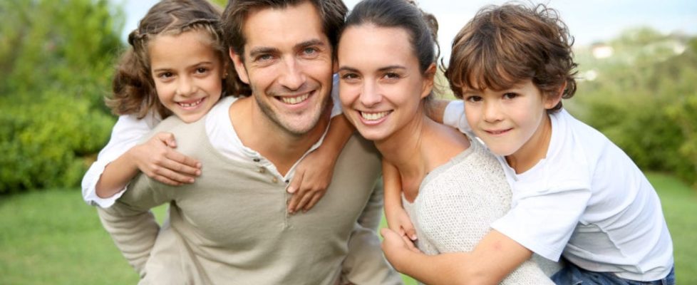 Parents giving piggyback ride to children